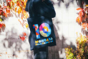 Person with tote bag over shoulder.
