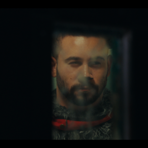 Man's face in dark frame.