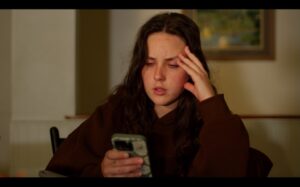 Image of person looking at phone.