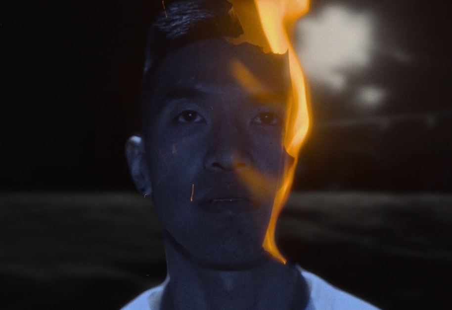 Image of a person looking forward as flame is on side of their face.