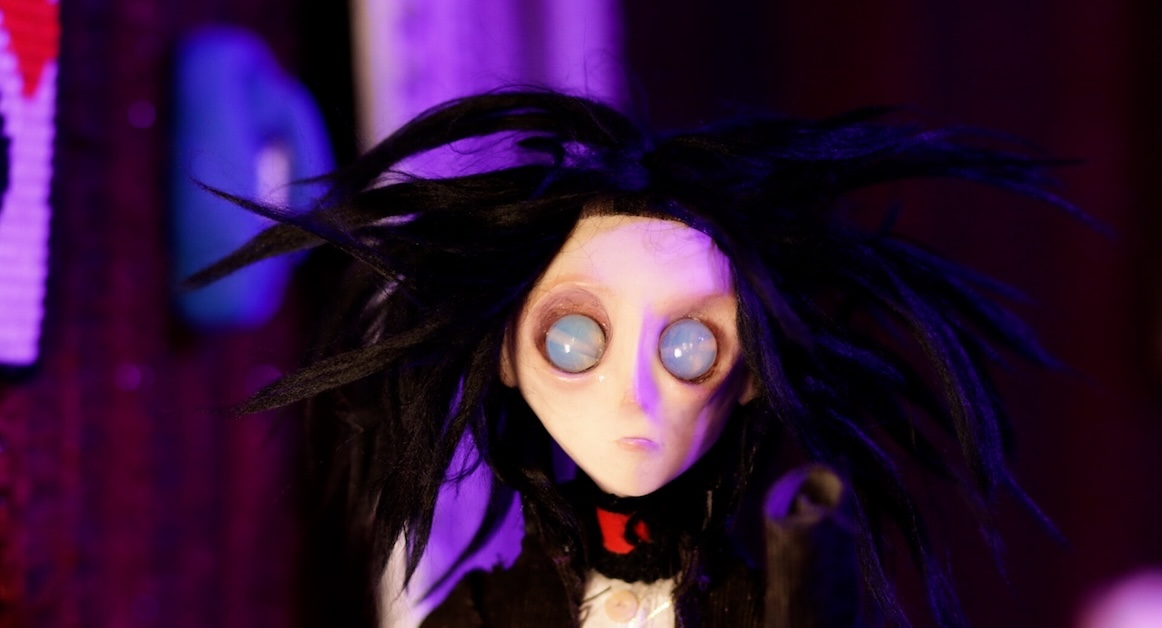 Image of stop motion animation of a close up of a person with black hair.