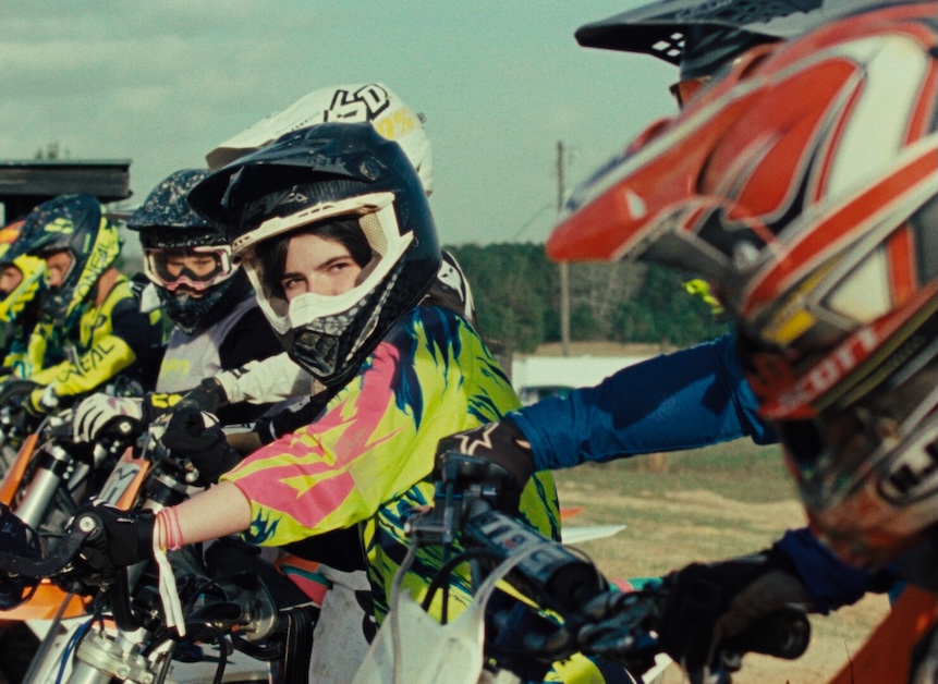 Image of person in helmet looking at another biker.