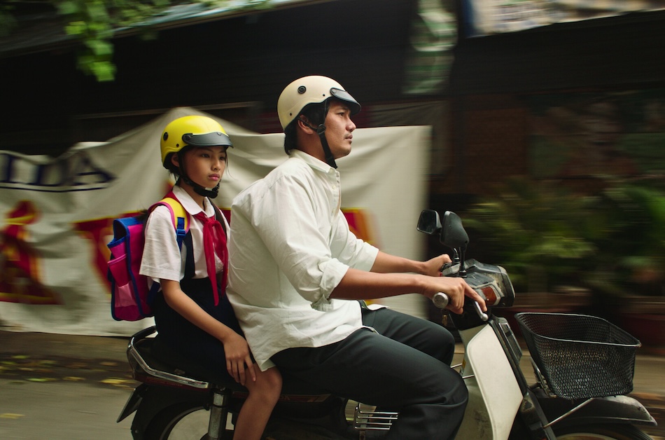 Image of adult and child on moped.