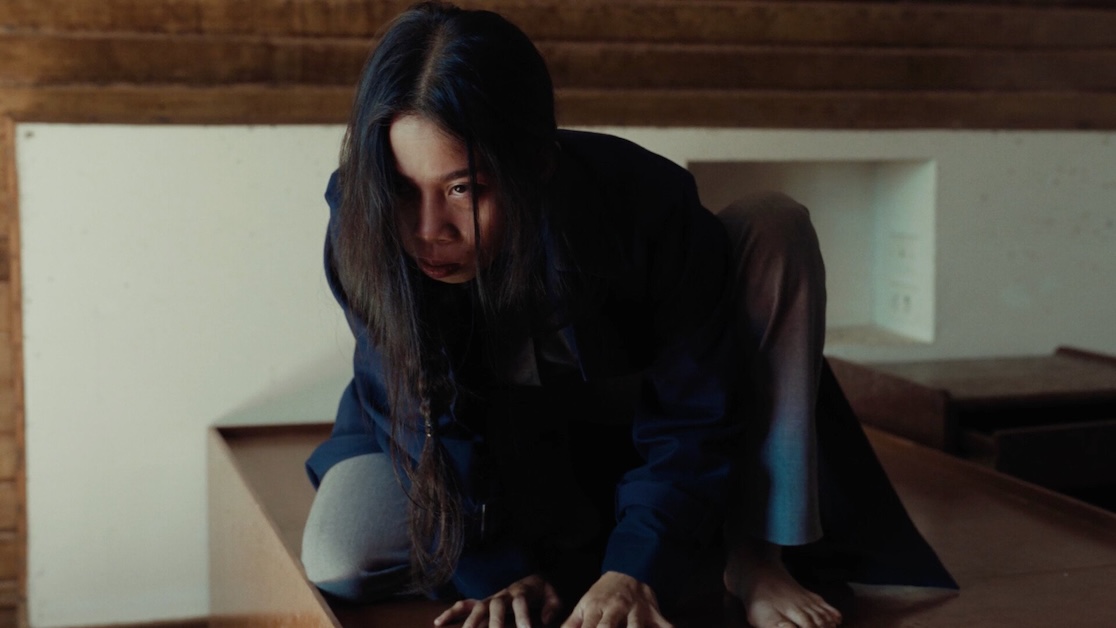 Image of a person crouched and looking forward.