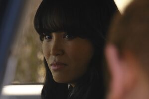 Person looks forward with other person off camera.