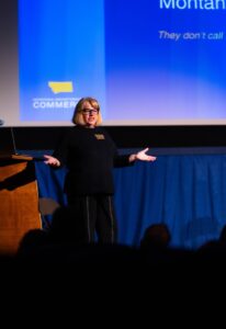 Image of person talking in front of blue screen.