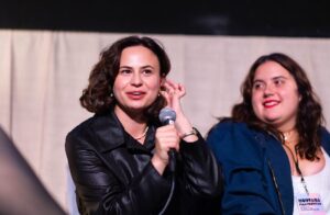 Image of person talking into microphone.