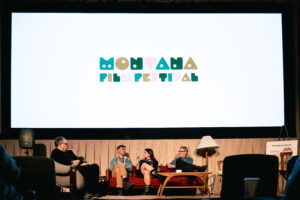 Inside of a movie theater with people on stage.