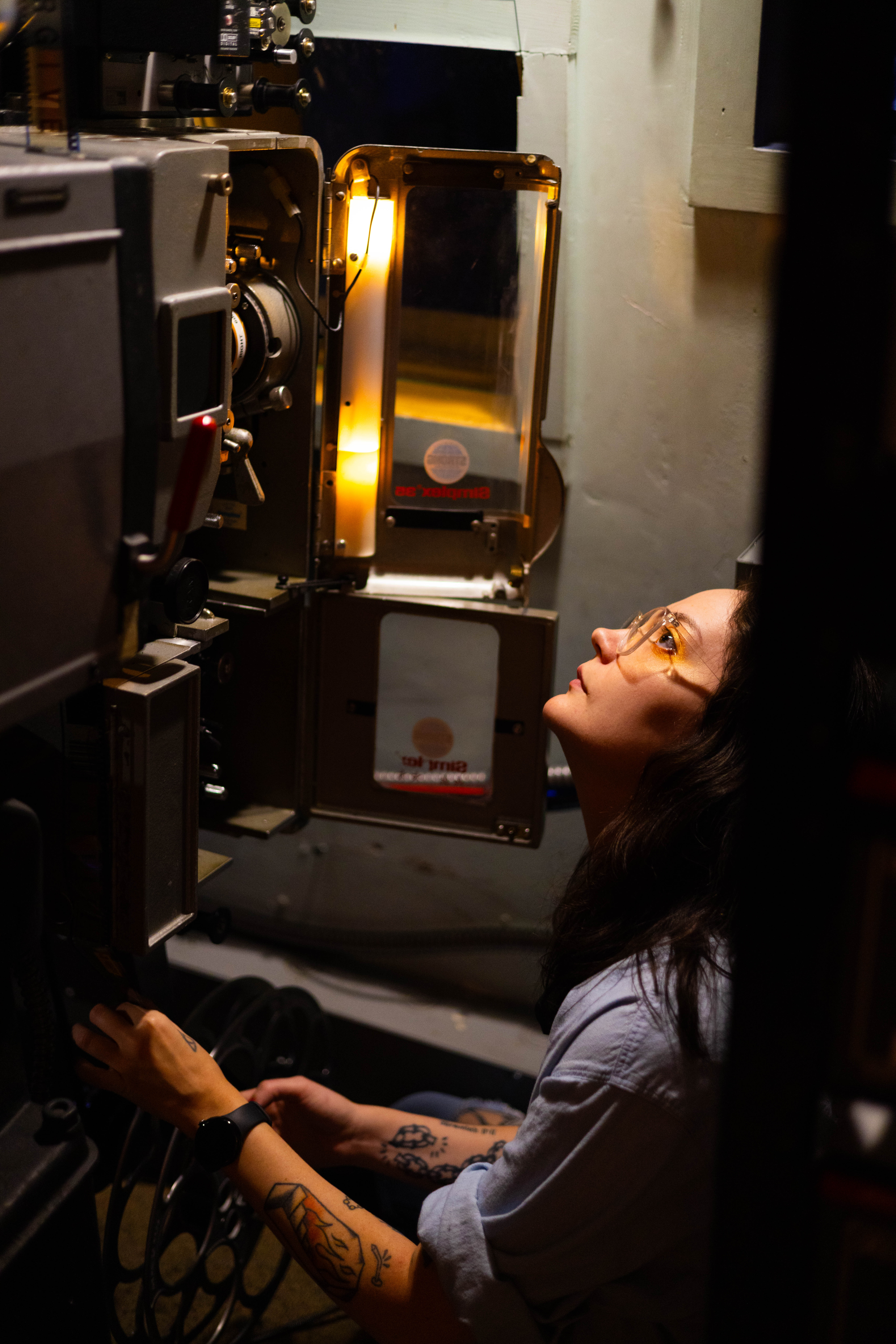 Person looking up at cinema projector