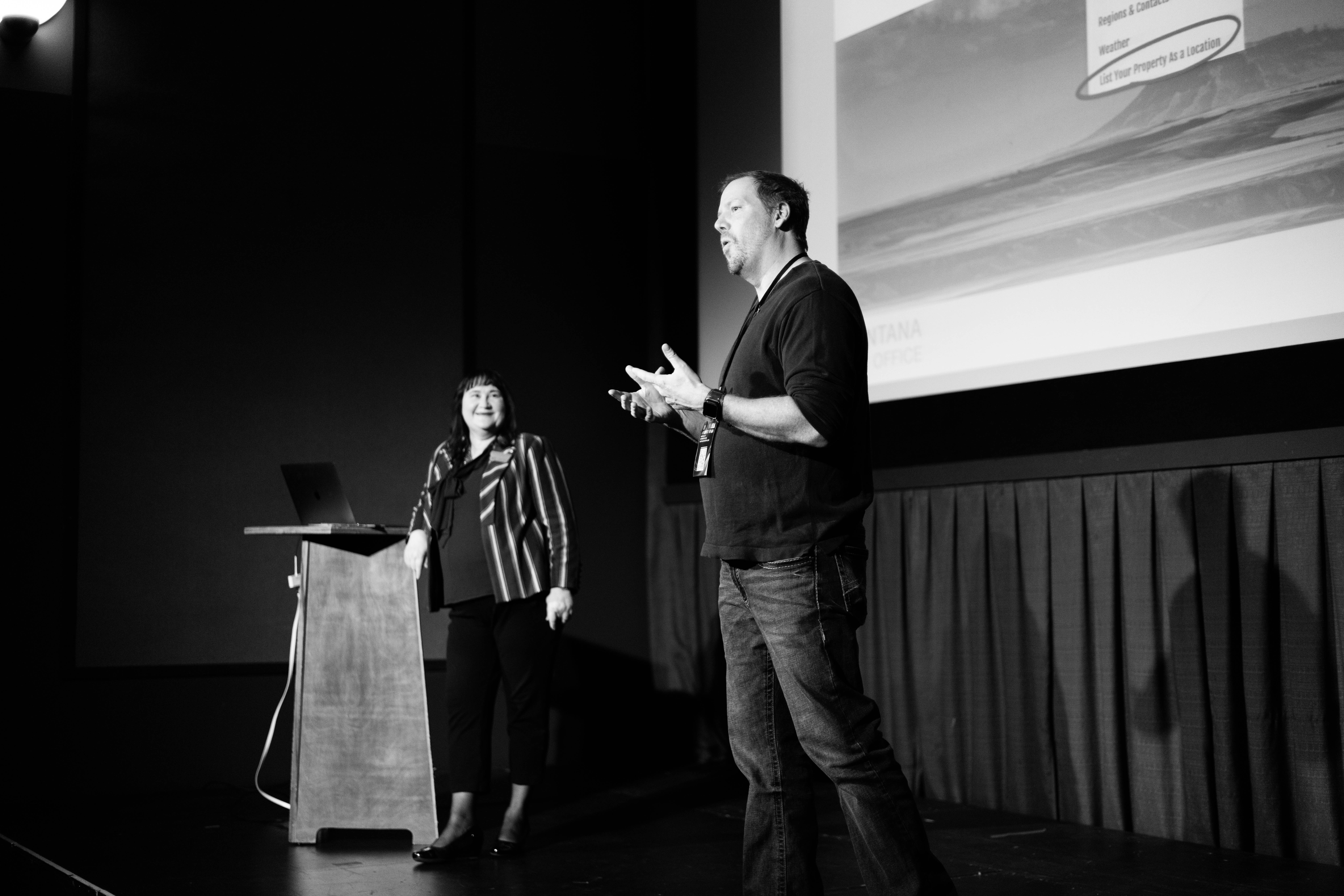 MTFF Day Three-04 Black and white photo of two people talking to audience on stage