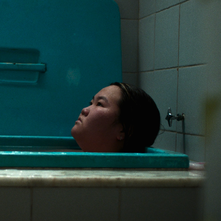 Person in bathtub looks left.