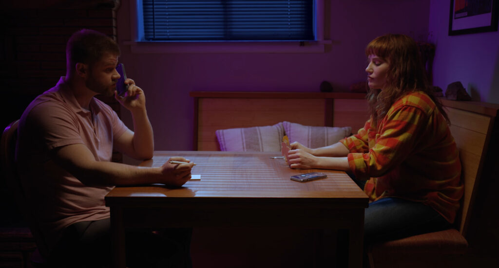 Two people sitting across from each other at a table