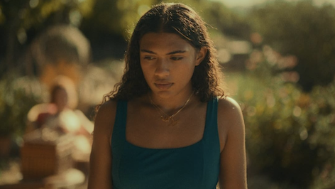 AZI Image of a person outside looking down.