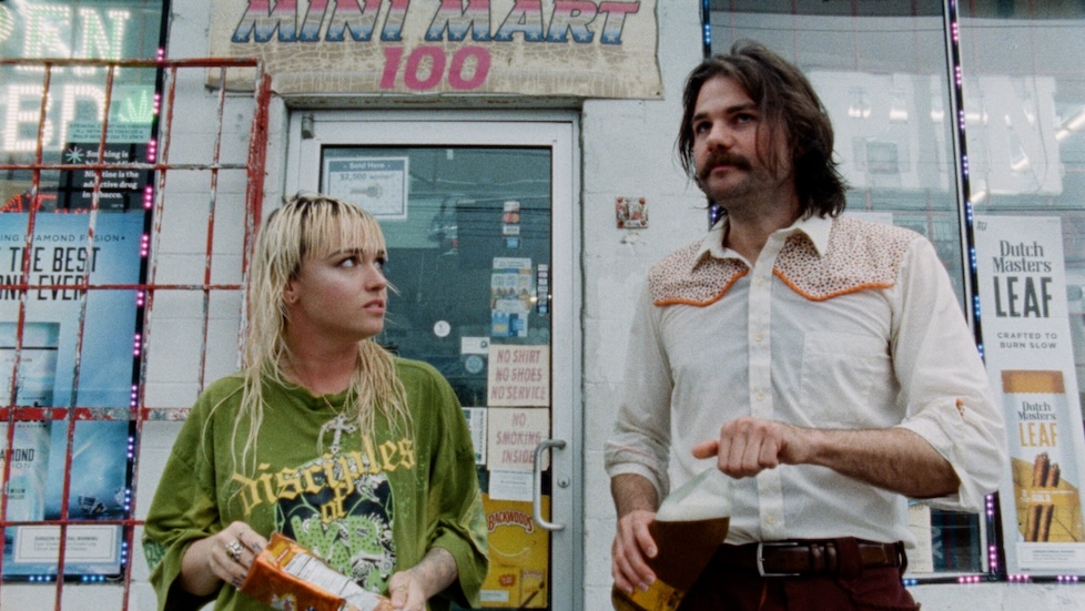 Image of two people standing outside a building.