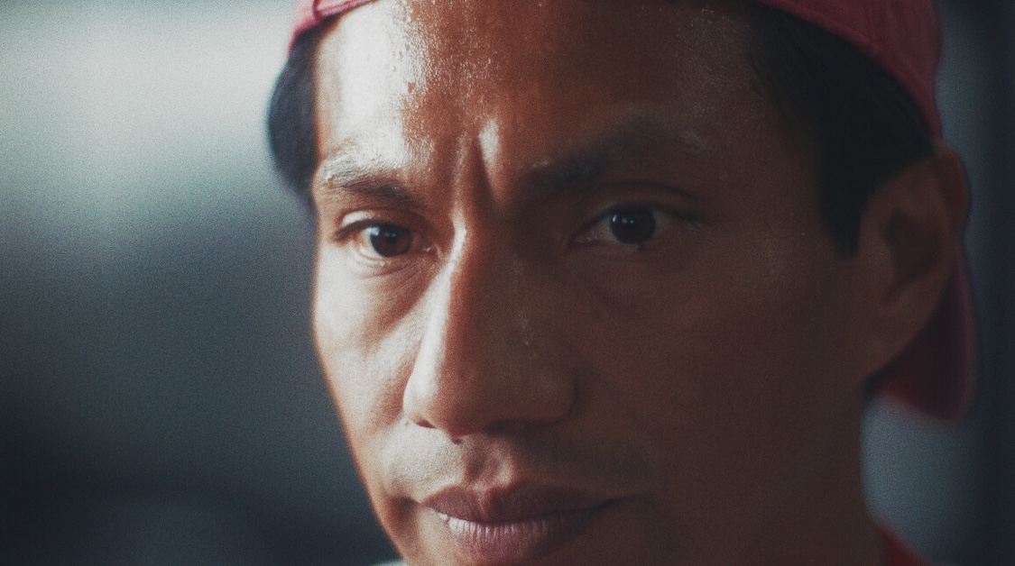 Image of person with pink hat looking forward.