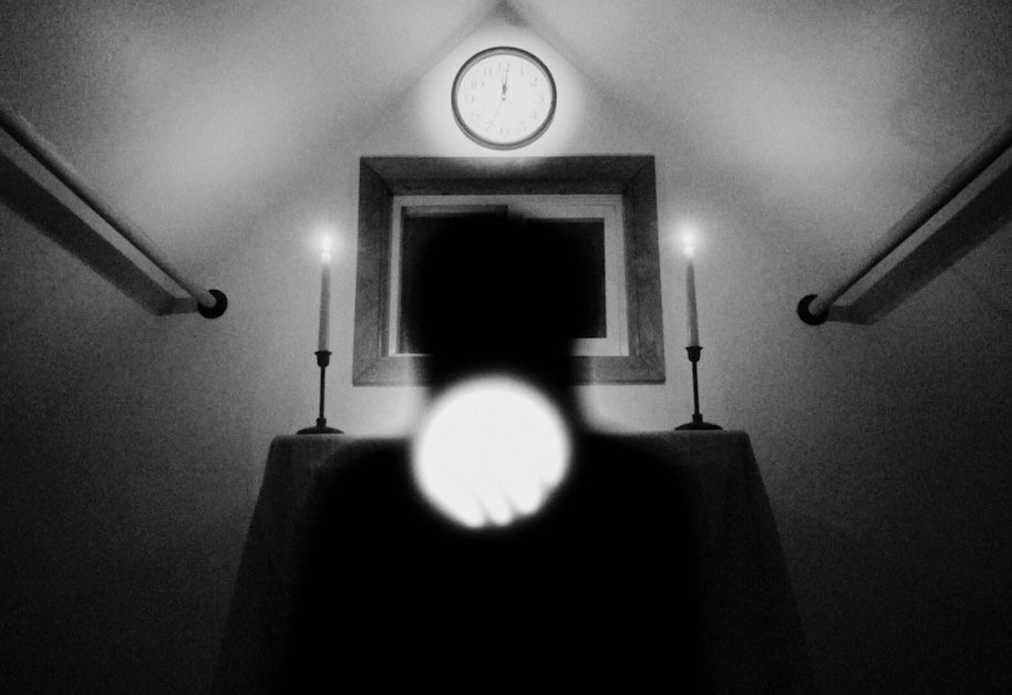 Image of black and white room with shadow in center.