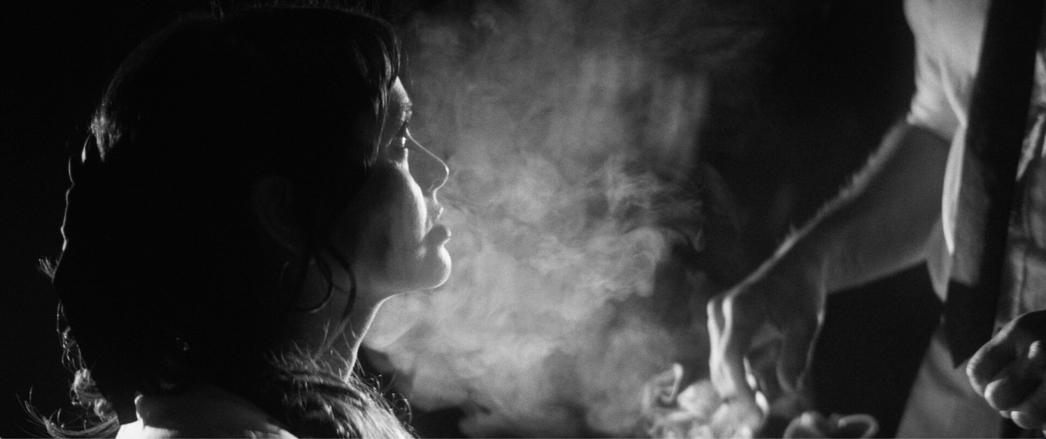 TOG2 Image of person looking up in smokey environment in black and white.