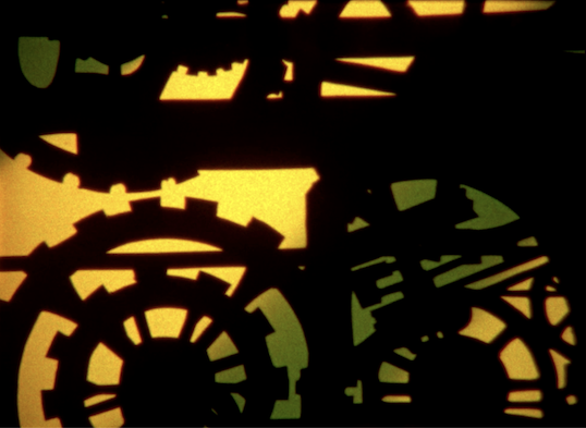 Image of gears and yellow and green background.