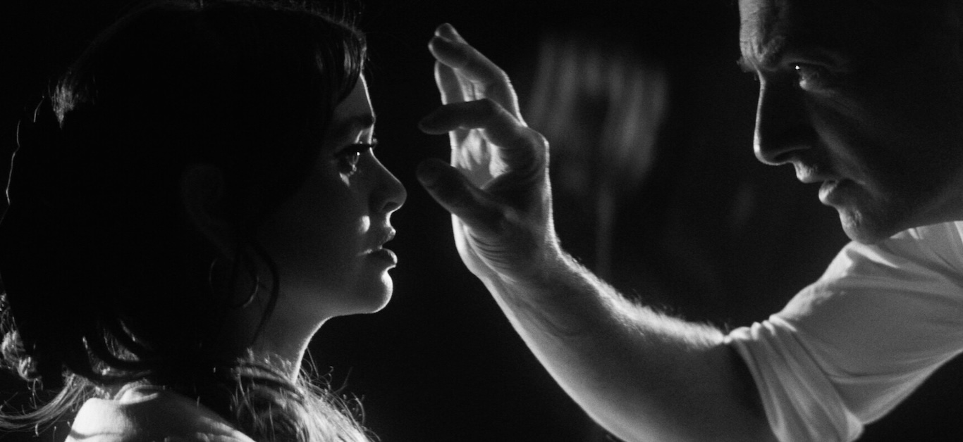 Image of person holding hand by other person's face.