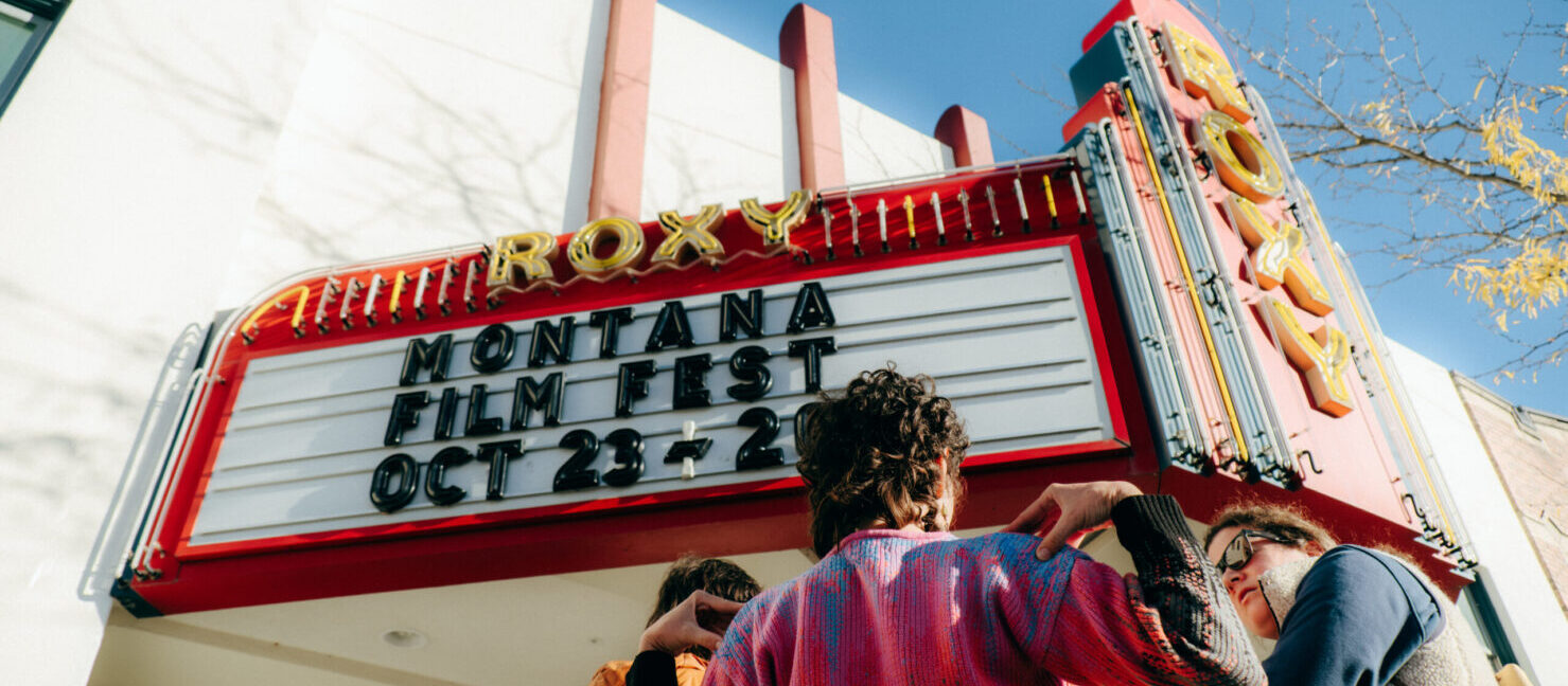 Marquee that says Montana Film Festival with people standing in front.