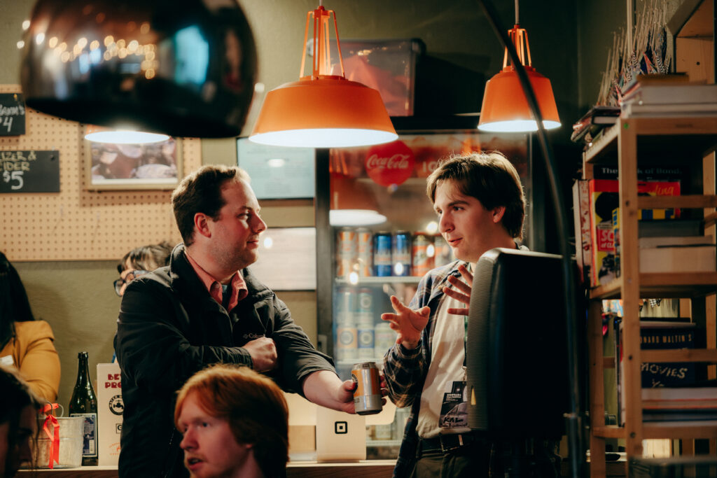 Two people talk at a party.