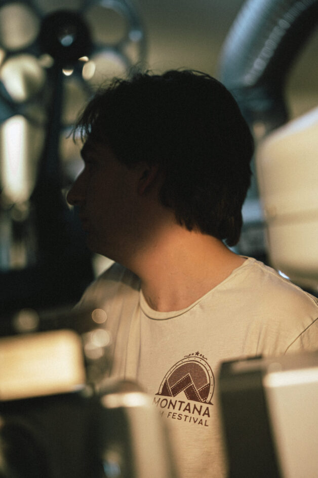 Person stands in projection booth.